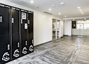 Thumbnail 16 of 30 - A row of black lockers with a white sign on the door at Saba Pompano Beach, Pompano Beach, 33062