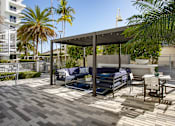 Thumbnail 19 of 30 - A patio with a couch and a table under a roof at Saba Pompano Beach, Pompano Beach, 33062