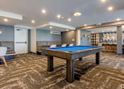 Thumbnail 12 of 30 - A room with a pool table and a chair at Saba Pompano Beach, Pompano Beach, 33062