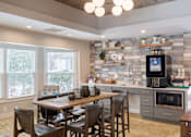 Thumbnail 8 of 16 - A kitchen with a dining table and chairs.