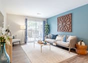 Thumbnail 4 of 16 - A living room with a blue vase and a white sofa.