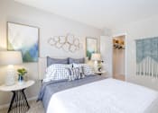 Thumbnail 5 of 16 - A bedroom with a large bed and a painting on the wall.