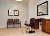 Thumbnail 9 of 23 - Two chairs with striped cushions sit in a waiting area.