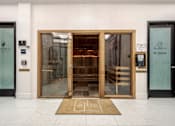 Thumbnail 23 of 36 - The entrance to a building with a glass door and a wooden door.
