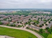 Thumbnail 69 of 69 - an aerial view of a neighborhood with houses and a road
