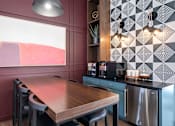 Thumbnail 29 of 51 - A modern kitchen with a wooden table and stainless steel appliances.