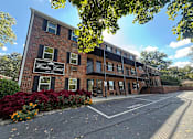 Thumbnail 21 of 24 - A building with a sign that says "Woodlawn Court" is shown.