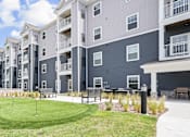 Thumbnail 26 of 30 - A large grassy area in front of apartment buildings.