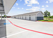Thumbnail 27 of 30 - A parking lot with a red line painted on the pavement.