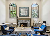 Thumbnail 9 of 33 - a living room with blue chairs and a fireplace