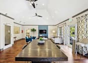 Thumbnail 15 of 33 - a large living room with a long wooden table and a tv