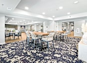 Thumbnail 13 of 30 - A large dining room with a black and white patterned carpet.