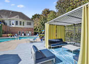 Thumbnail 18 of 33 - a pool with lounge chairs and umbrellas and a house in the background