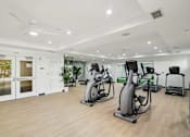 Thumbnail 6 of 39 - A gym with treadmills, exercise bikes, and other equipment.