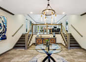 Thumbnail 8 of 33 - the entryway of a house with a glass table and stairs