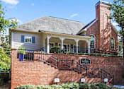 Thumbnail 28 of 33 - the front of a brick house with stairs and a porch
