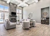 Thumbnail 4 of 51 - A modern living room with a stone fireplace and a flat screen TV.