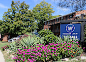 Thumbnail 13 of 24 - A sign for Windsor Court is in front of a building.