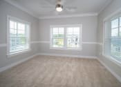 Thumbnail 42 of 54 - an empty room with three windows and a ceiling fan