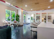 Thumbnail 2 of 22 - A white reception desk with a green chair in front of it.