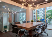 Thumbnail 5 of 22 - A conference room with a long table and chairs.
