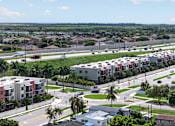 Thumbnail 34 of 35 - A view of a residential area with apartment buildings and palm trees.