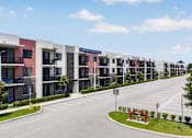Thumbnail 31 of 35 - A row of modern apartment buildings with balconies and a clear blue sky above.