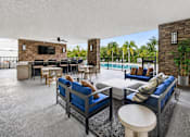 Thumbnail 19 of 35 - A living room with a television and a pool outside.