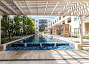 Thumbnail 23 of 30 - A long rectangular pool with a waterfall in the middle.