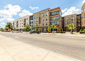 Thumbnail 30 of 30 - A street view of a residential area with cars parked on the side of the road.