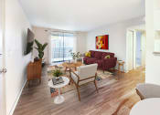 Thumbnail 8 of 27 - a living room with a couch and a chair and a table