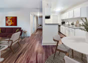 Thumbnail 7 of 27 - a living room with a kitchen and a dining room