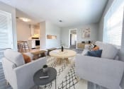 Thumbnail 4 of 23 - a living room with couches and a table