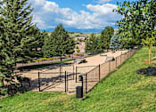 Thumbnail 23 of 37 - A playground with a fence and slide.