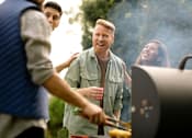 Thumbnail 27 of 28 - a group of men and women grilling food on a grill