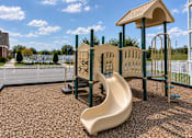 Thumbnail 21 of 22 - A playground with a slide and a wooden structure.