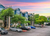 Thumbnail 29 of 31 - a row of town houses with cars parked in front of them