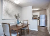 Thumbnail 24 of 44 - an open kitchen and dining room with a table and chairs
