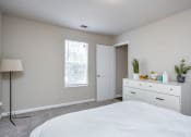 Thumbnail 28 of 44 - a bedroom with white cabinets and a white bed