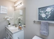 Thumbnail 29 of 44 - a bathroom with a sink and a mirror and a towel rack