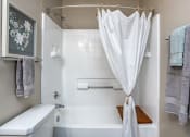Thumbnail 30 of 44 - a bathroom with a shower curtain and a tub and a sink