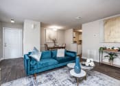Thumbnail 25 of 44 - a living room with a blue couch and a table