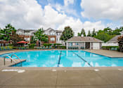 Thumbnail 24 of 29 - A large swimming pool in front of a building.