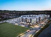Thumbnail 5 of 5 - Murfreesboro, TN, Luxury Apartments Near Target - Vintage 1959 - Aerial View Of A Modern Apartment Community With Lighted Building Exteriors, Parking Areas, and Landscaped Grounds.