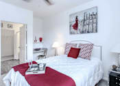 Thumbnail 7 of 29 - a bedroom with a white bed with red pillows