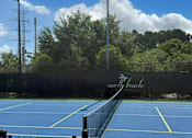 Thumbnail 22 of 31 - A tennis court with a black fence and the words "North Beach" written on it.