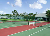 Thumbnail 17 of 21 - Setting up a game on the on-site tennis court will be an amenity you'll love at Lake in the Woods, Melbourne, FL, 32901