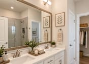 Thumbnail 38 of 56 - A bathroom with two sinks and a large mirror.