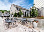 Thumbnail 56 of 56 - A patio with a table and chairs is surrounded by a black fence.