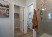 Thumbnail 28 of 56 - A bathroom with a towel hanging on the shower door.